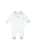 White baby onesie with beige accents on a white background