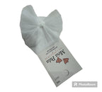 A pair of white ankle socks with a knotted tulle bow on the side, with the Meia Pata brand tag visible.