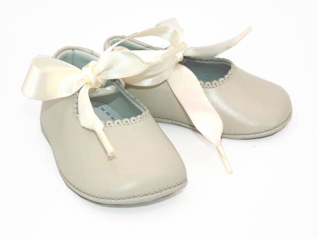 Made of 100% mother-of-pearl leather origin and free of toxic products.  Ivory pre-walker shoes for baby Girl  Trimmed with pretty Satin detailing, they fasten with organza bows on the front for an adorable look. Made in super soft leather with a sheen, they have a comfortable fabric lining and a cushioned sole for the baby's little feet.